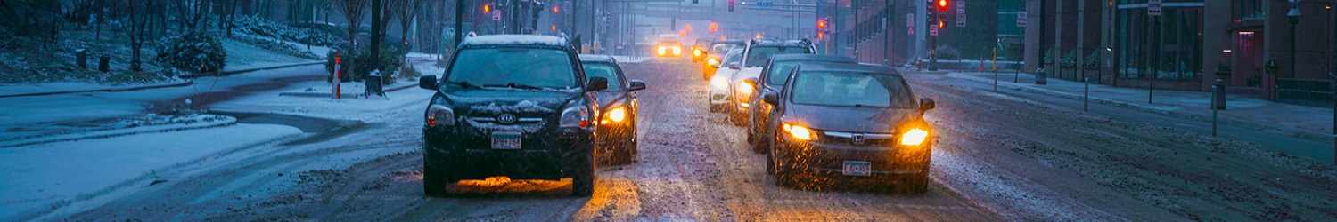 image of cars on a snowy road in downtown Minneapolis stopped at a stoplight